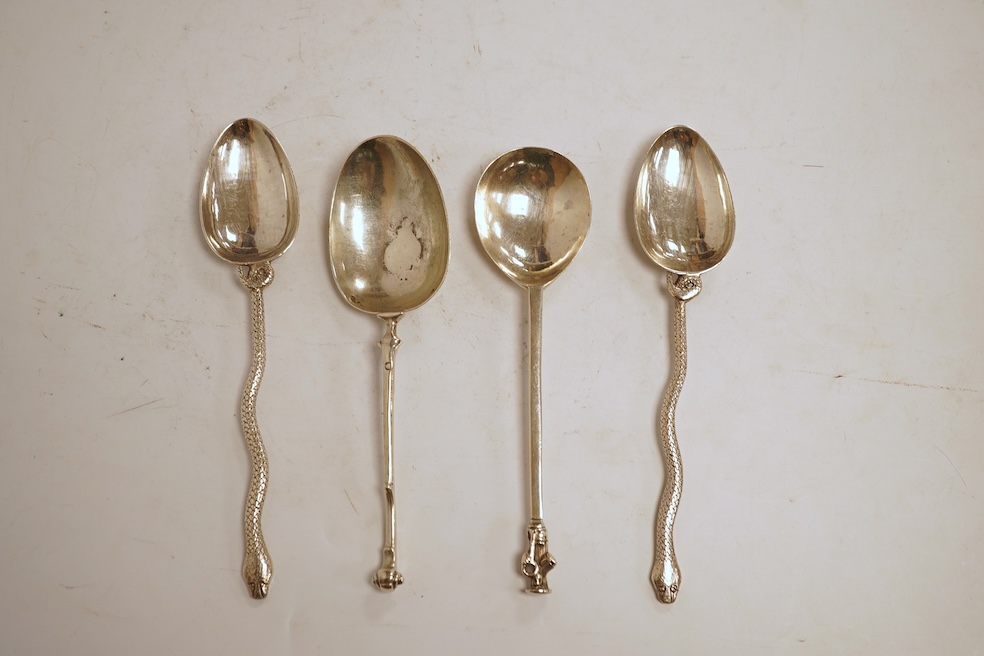 An 18th century silver apostle spoon, indistinct marks, 17cm, a continental white metal spoon with scroll handle and a pair of unmarked white metal spoons with serpent handles.